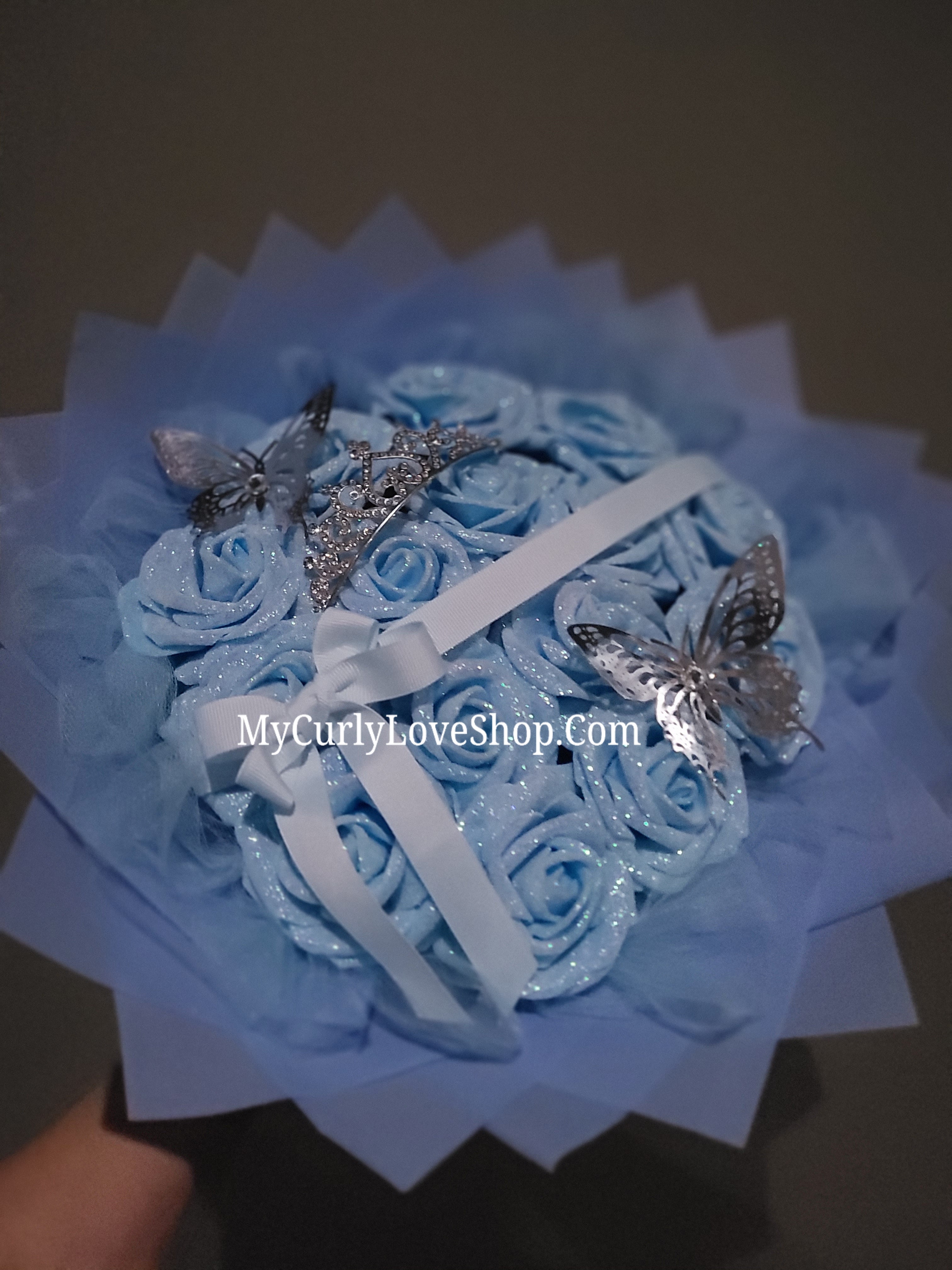 Blue Glitter Roses Bouquet: Silver Tiara and Butterfly Included (Tiara and Butterfly Shape Can Vary Depending on Availability) Banner and Lights are additional.