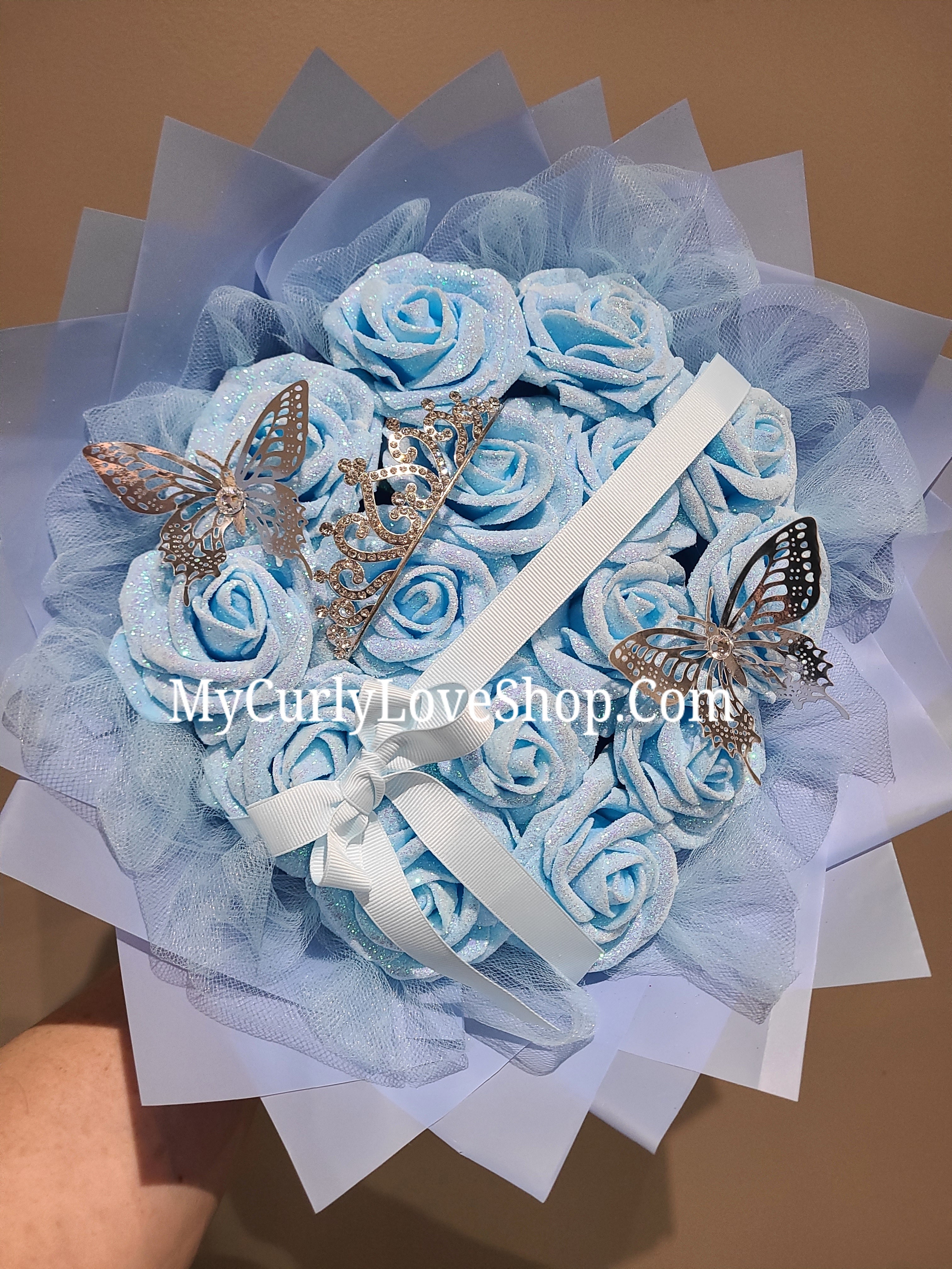 Blue Glitter Roses Bouquet: Silver Tiara and Butterfly Included (Tiara and Butterfly Shape Can Vary Depending on Availability) Banner and Lights are additional.
