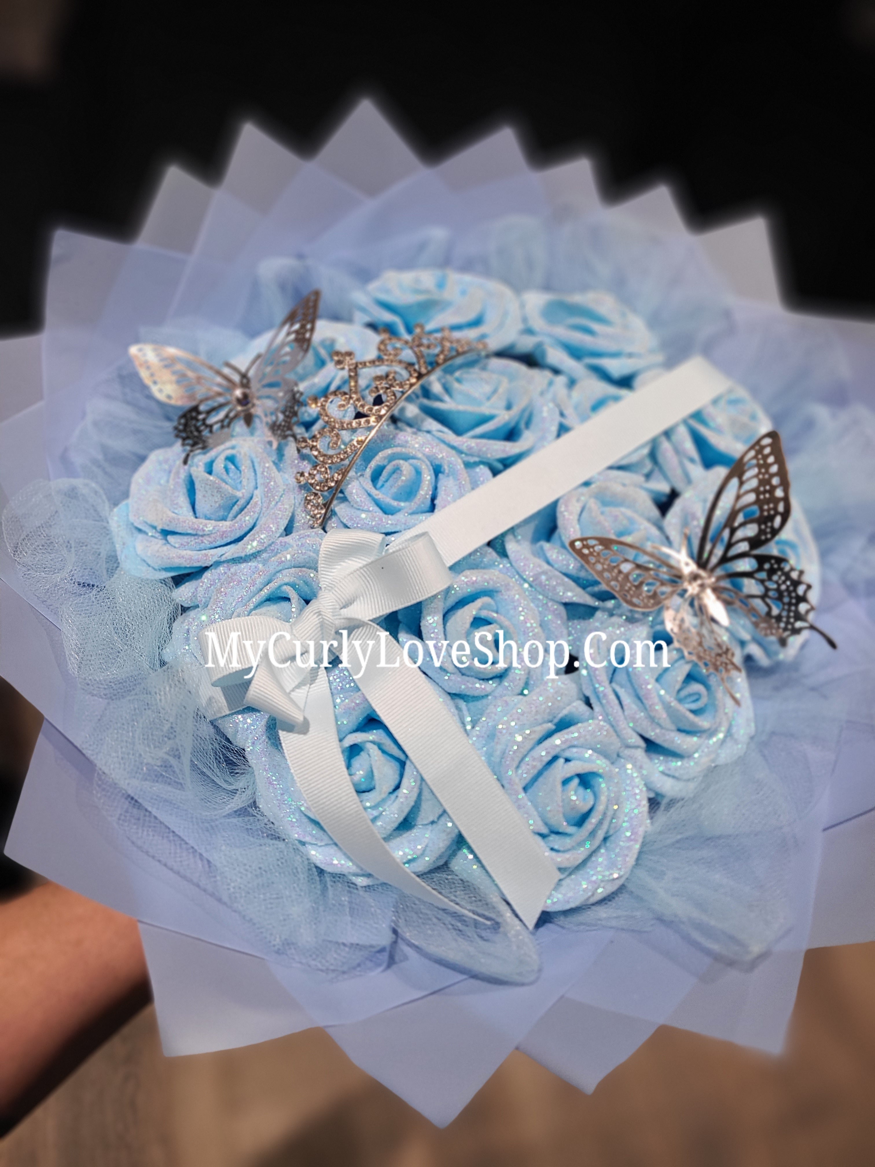 Blue Glitter Roses Bouquet: Silver Tiara and Butterfly Included (Tiara and Butterfly Shape Can Vary Depending on Availability) Banner and Lights are additional.