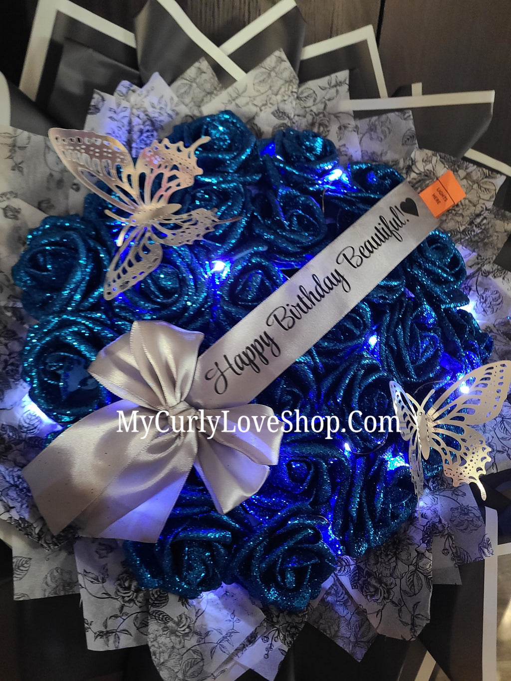 Floral Glitter Roses Bouquet. Comes with two silver butterflies. Banner and Lights are additional. See selection.