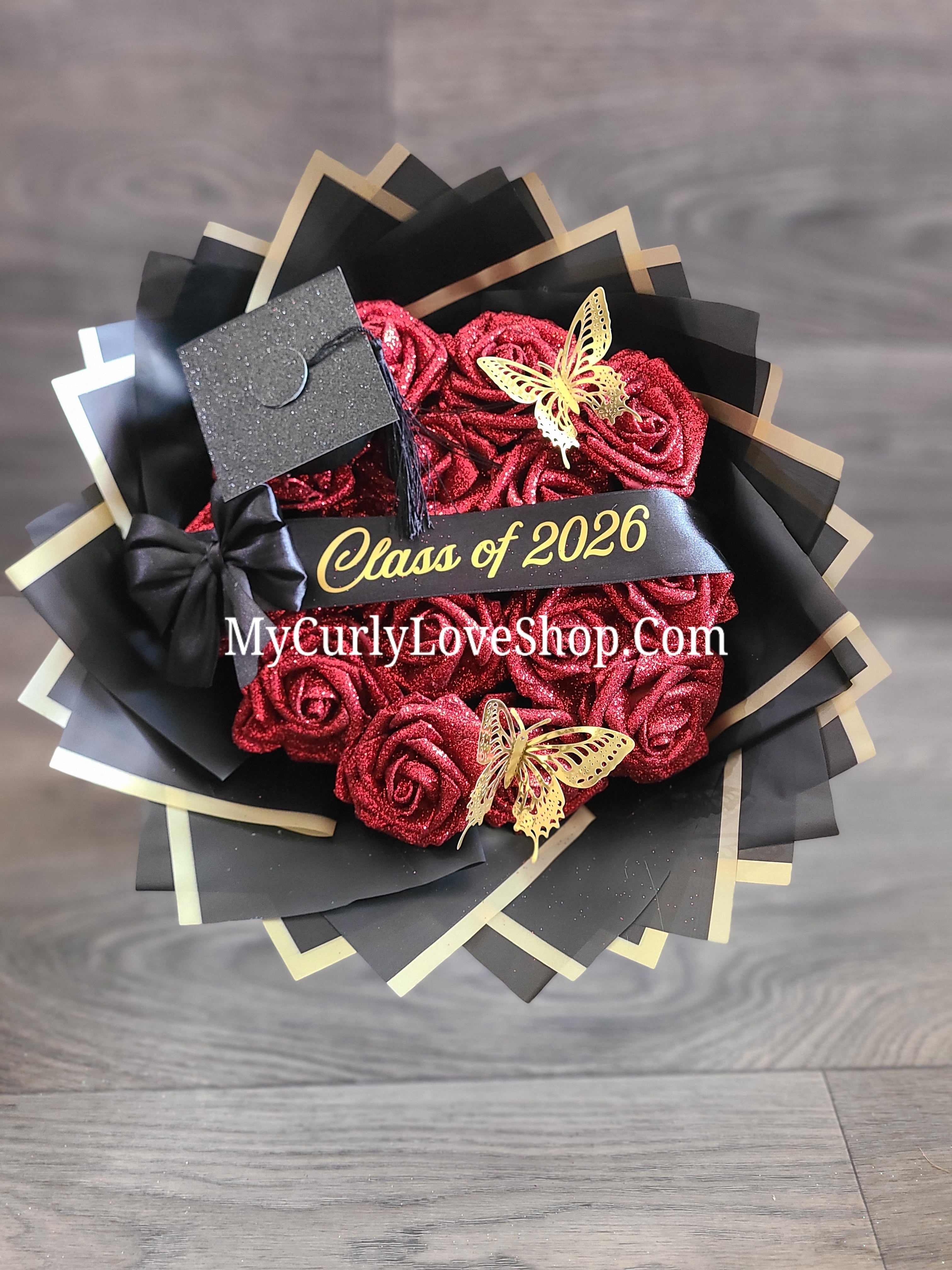 Graduation Glitter Roses Bouquet. Graduation Cap and 2 gold butterflies Included. Banner and Lights are additional.