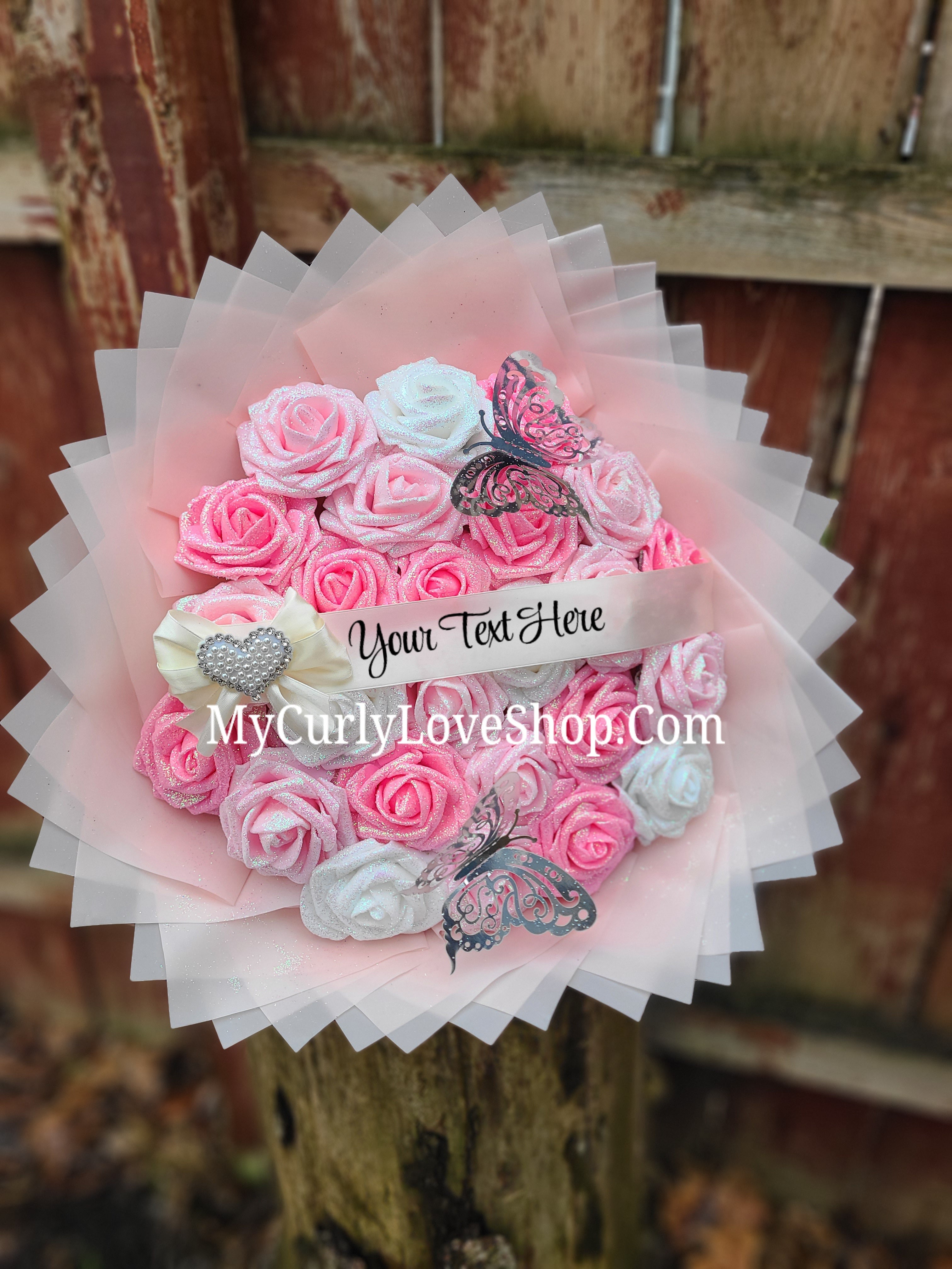 Bouquet comes as shown:
(25 Roses, Personalized Ribbon, 2 Silver Butterflies and Heart Embellishment Included). 
Lights are additional. See selection.