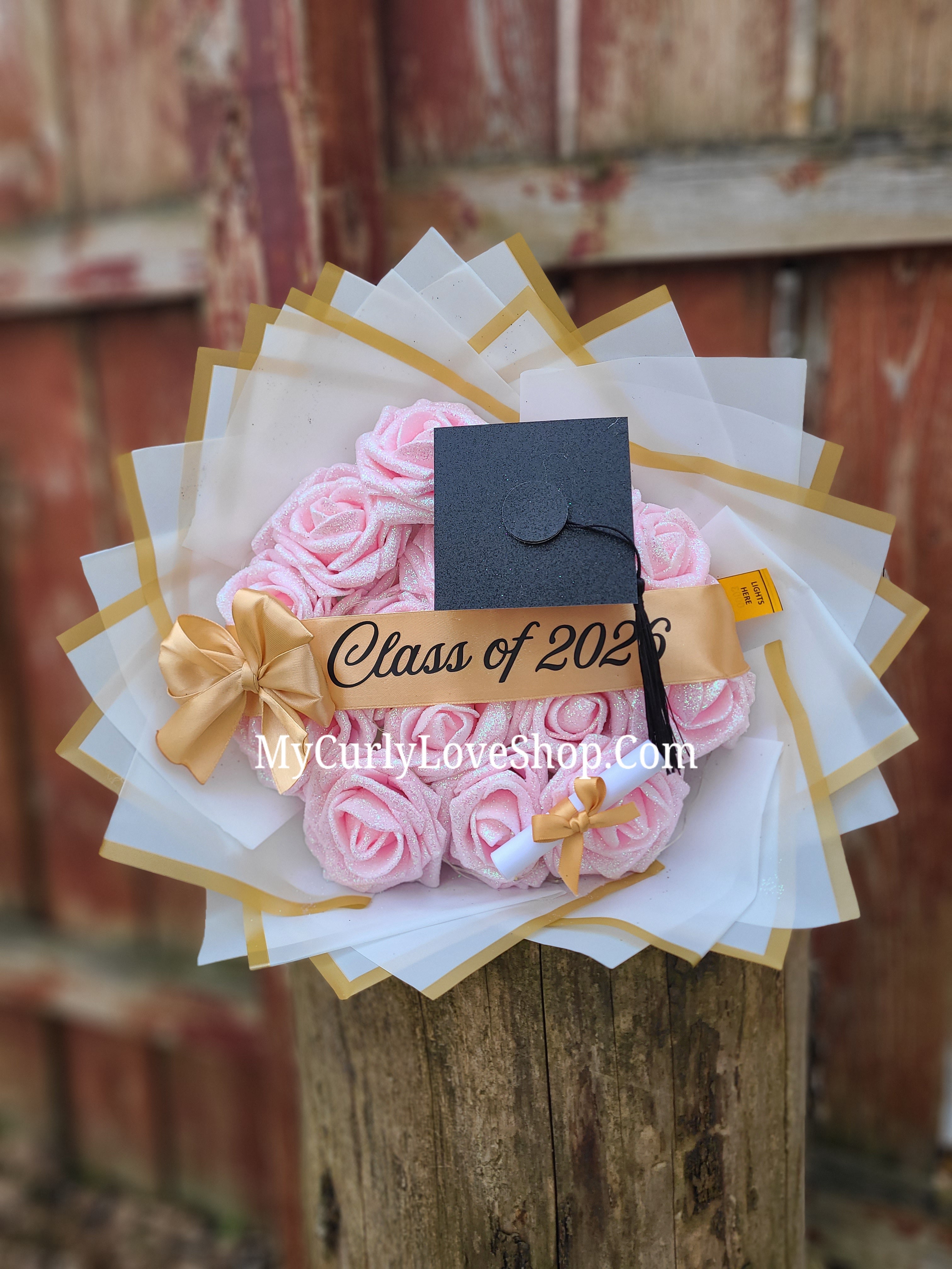 Graduation Glitter Roses Bouquet. Graduation Cap and Diploma Embellishment Included. Name on the Cap, Banner and Lights are additional.
