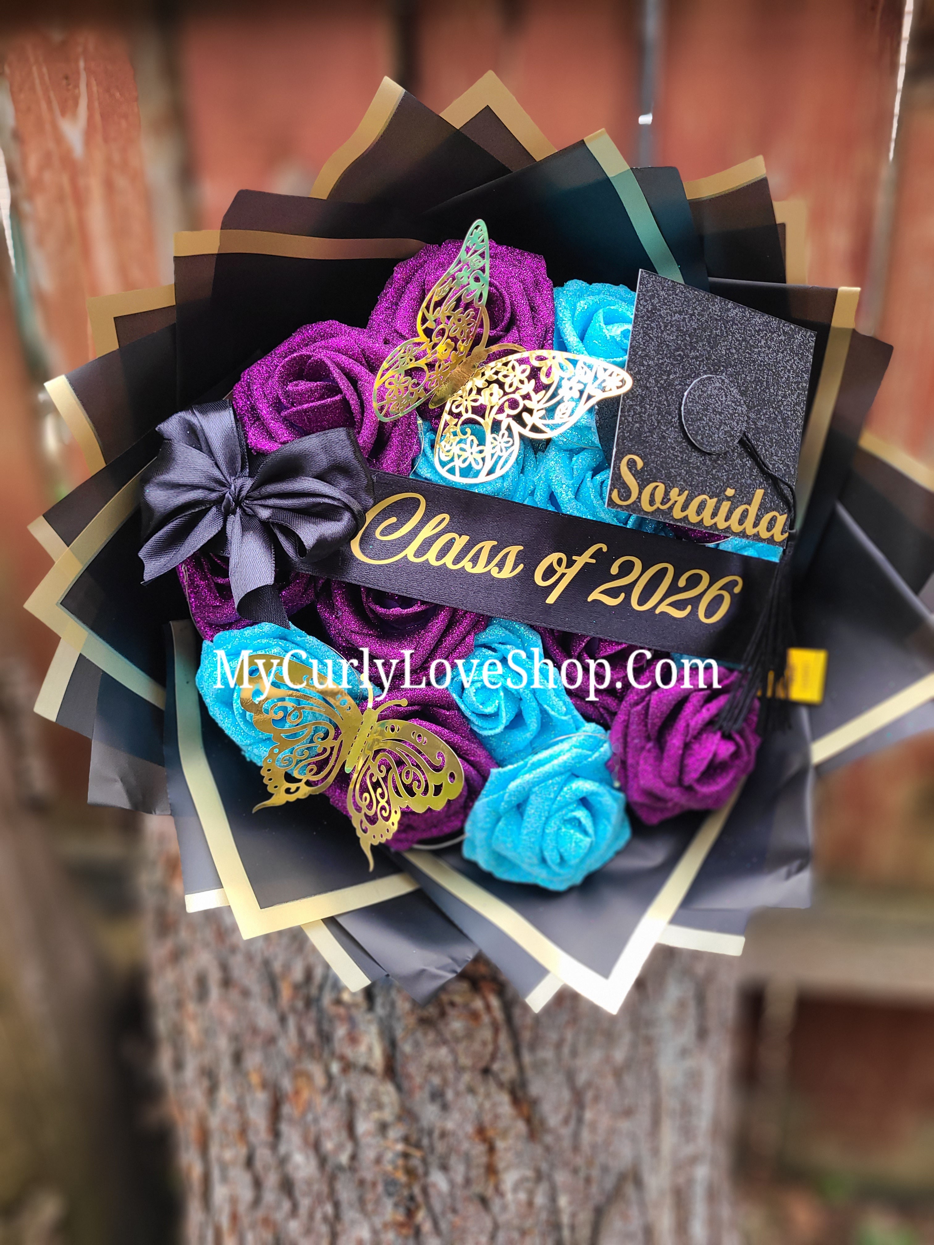 Graduation Glitter Roses Bouquet. Graduation Cap and 2 gold butterflies Included. Banner and Lights are additional.