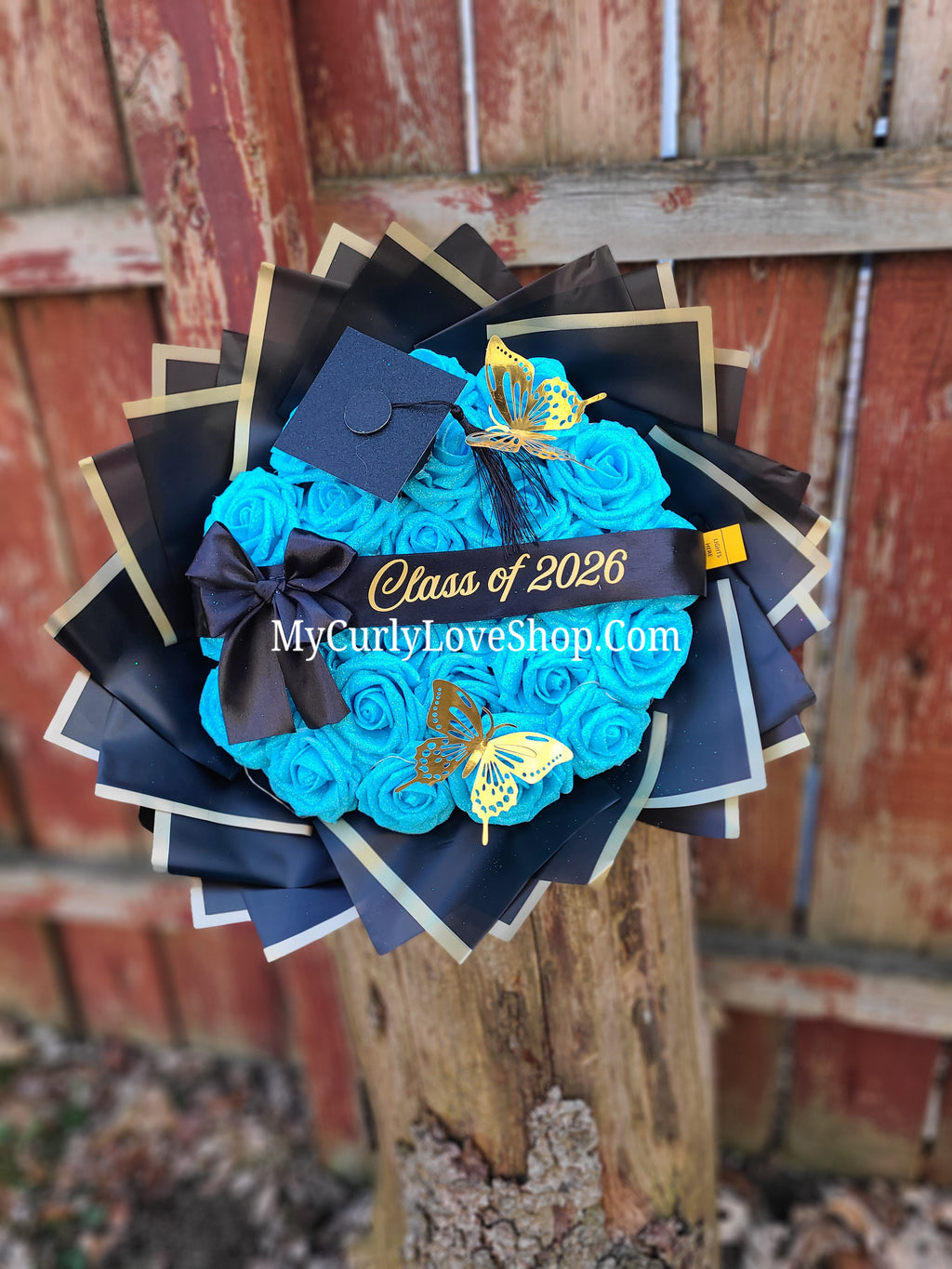 Graduation Glitter Roses Bouquet. Graduation Cap and 2 gold butterflies Included. Banner and Lights are additional.