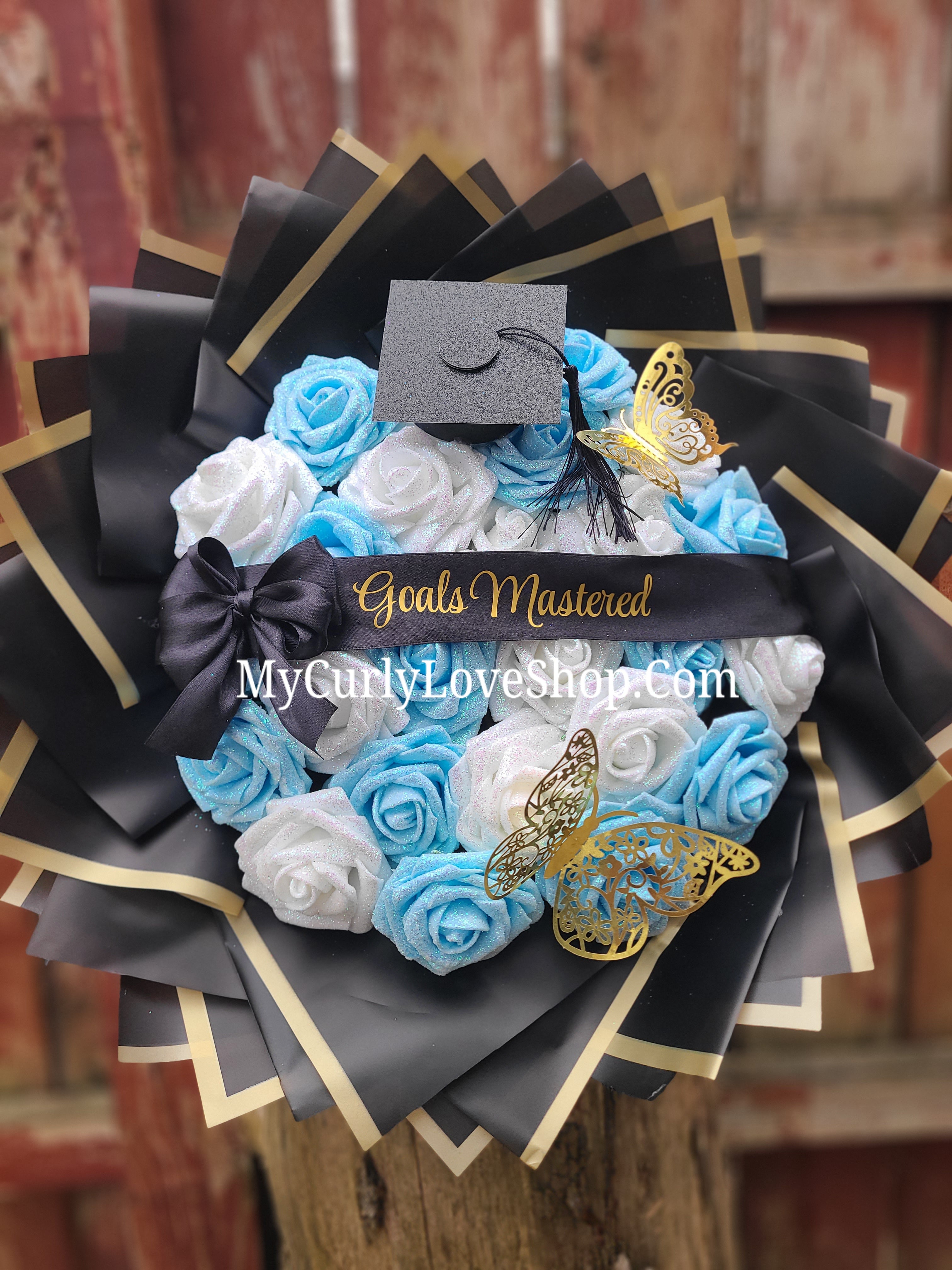 Graduation Glitter Roses Bouquet. Graduation Cap and 2 gold butterflies Included. Banner and Lights are additional.