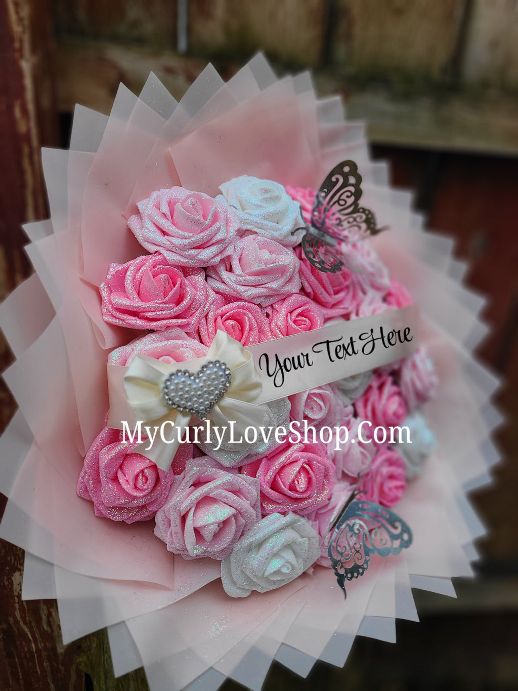 Bouquet comes as shown:
(25 Roses, Personalized Ribbon, 2 Silver Butterflies and Heart Embellishment Included). 
Lights are additional. See selection.