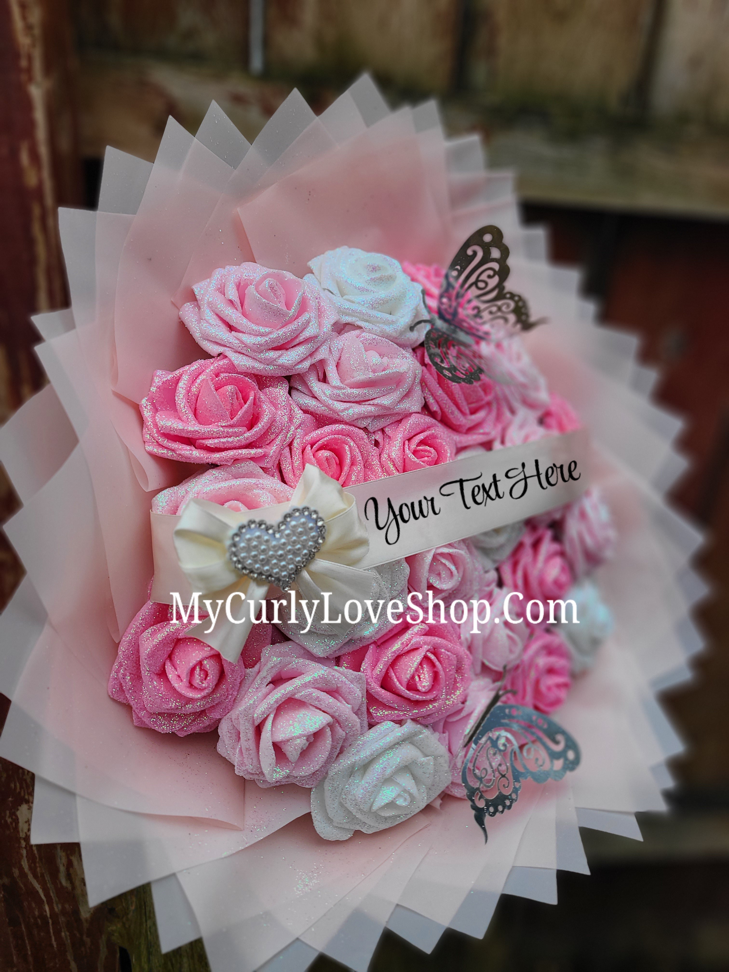 Bouquet comes as shown:
(25 Roses, Personalized Ribbon, 2 Silver Butterflies and Heart Embellishment Included). 
Lights are additional. See selection.