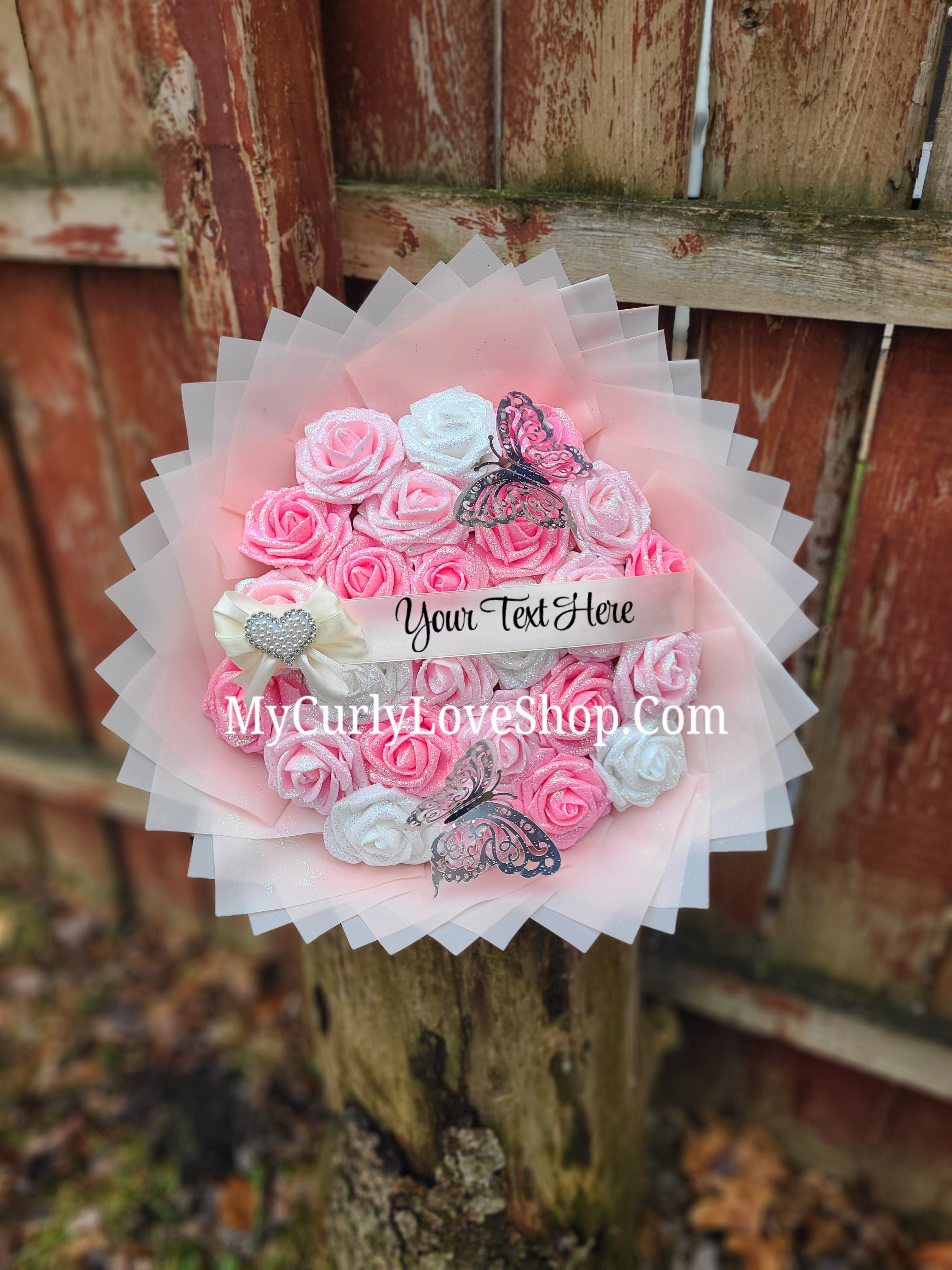 Bouquet comes as shown:
(25 Roses, Personalized Ribbon, 2 Silver Butterflies and Heart Embellishment Included). 
Lights are additional. See selection.