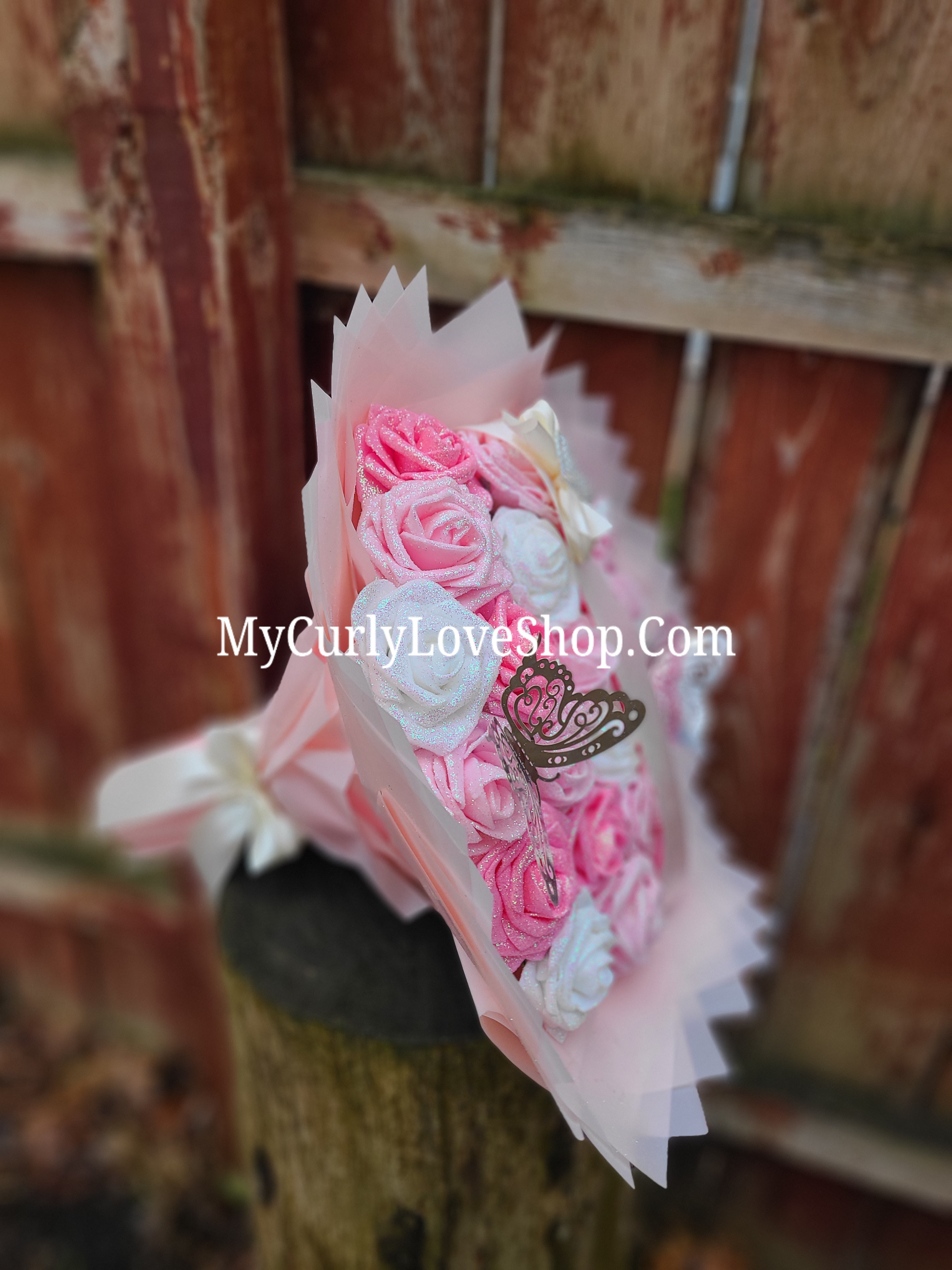 Bouquet comes as shown:
(25 Roses, Personalized Ribbon, 2 Silver Butterflies and Heart Embellishment Included). 
Lights are additional. See selection.