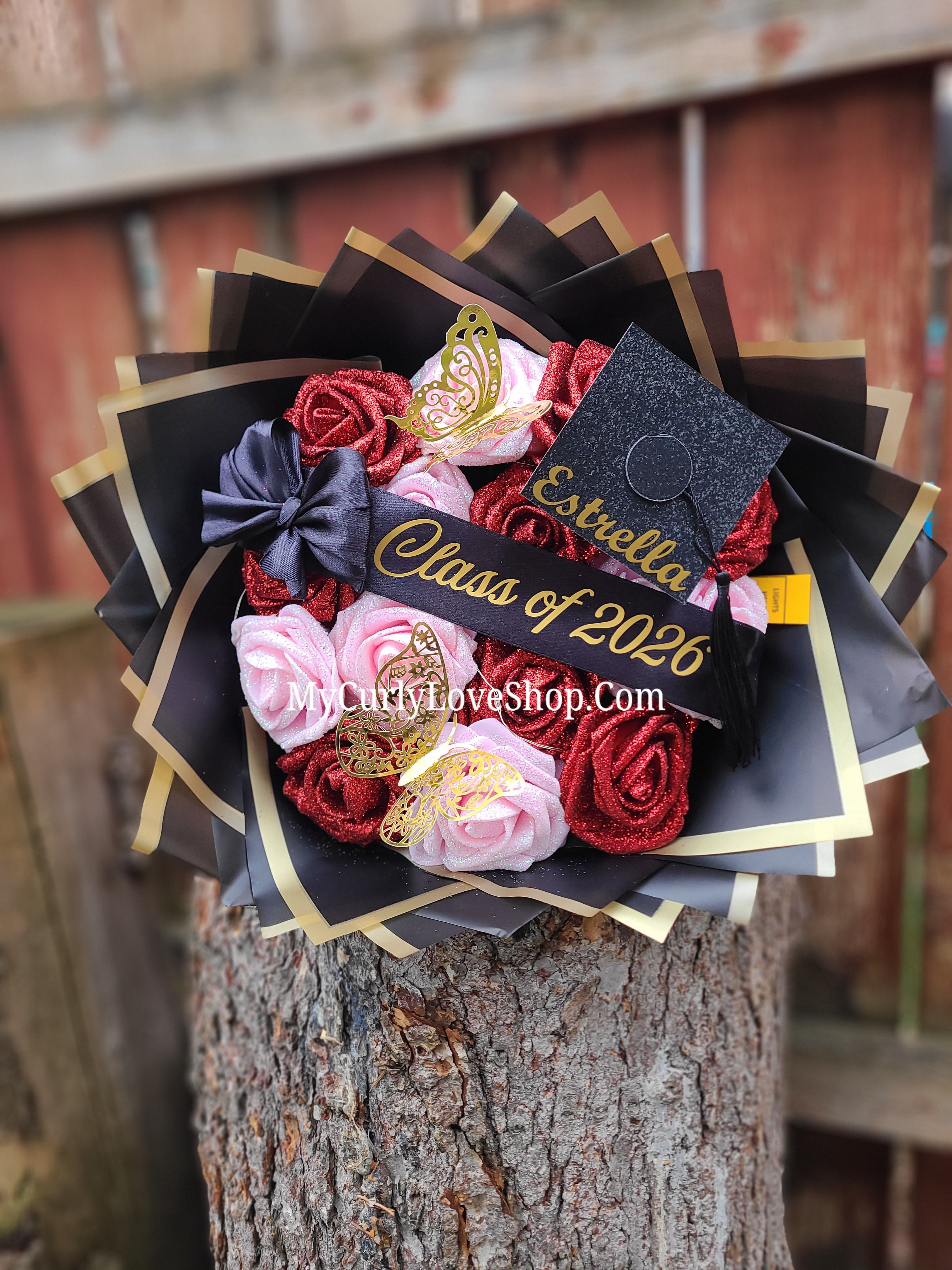 Graduation Glitter Roses Bouquet. Graduation Cap and 2 gold butterflies Included. Banner and Lights are additional.