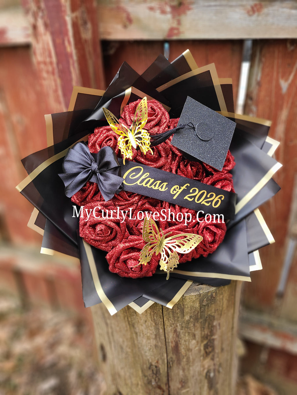 Graduation Glitter Roses Bouquet. Graduation Cap and 2 gold butterflies Included. Banner and Lights are additional.