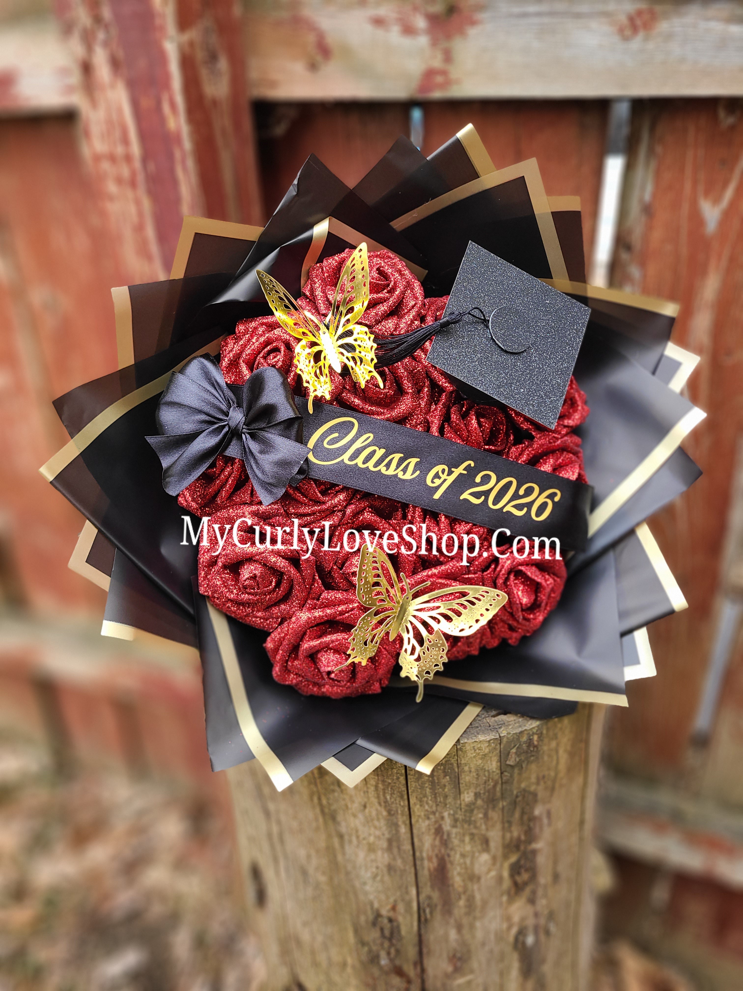 Graduation Glitter Roses Bouquet. Graduation Cap and 2 gold butterflies Included. Banner and Lights are additional.