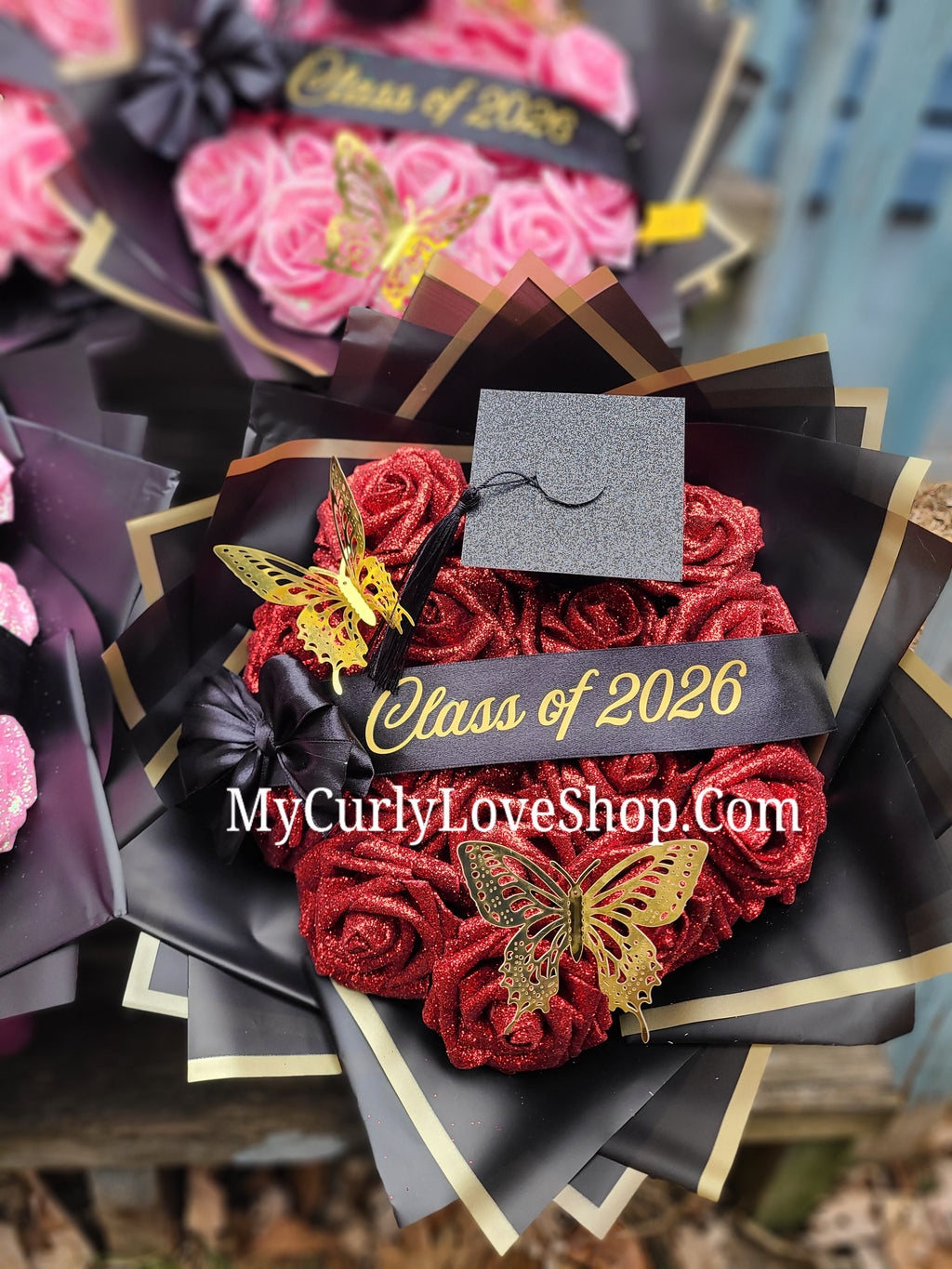 Graduation Glitter Roses Bouquet. Graduation Cap and 2 gold butterflies Included. Banner and Lights are additional.