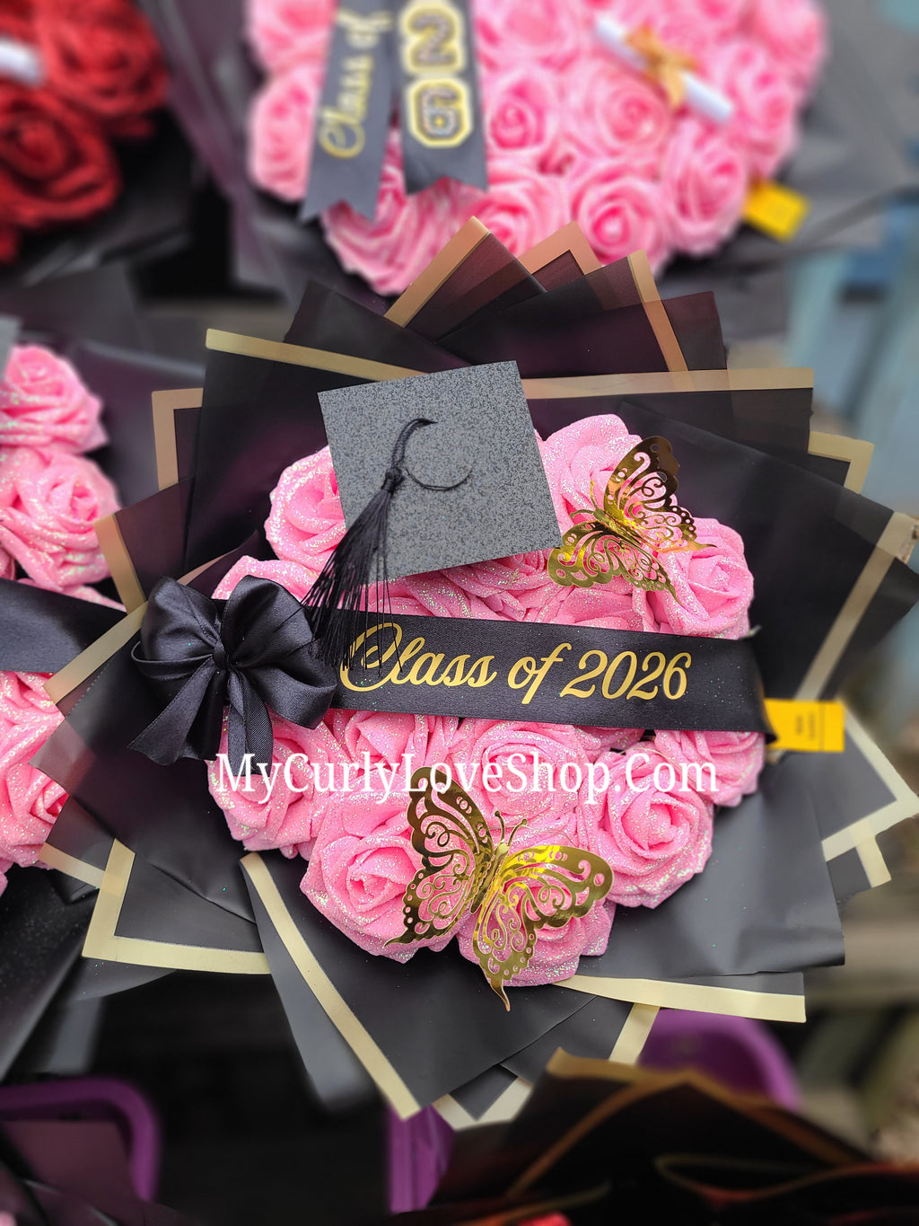 Graduation Glitter Roses Bouquet. Graduation Cap and 2 gold butterflies Included. Banner and Lights are additional.